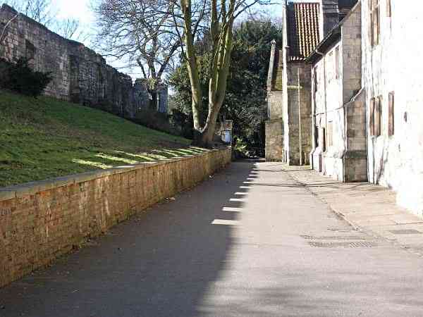 Looking along the lane and the medieval city wall towards the Museum Gardens.